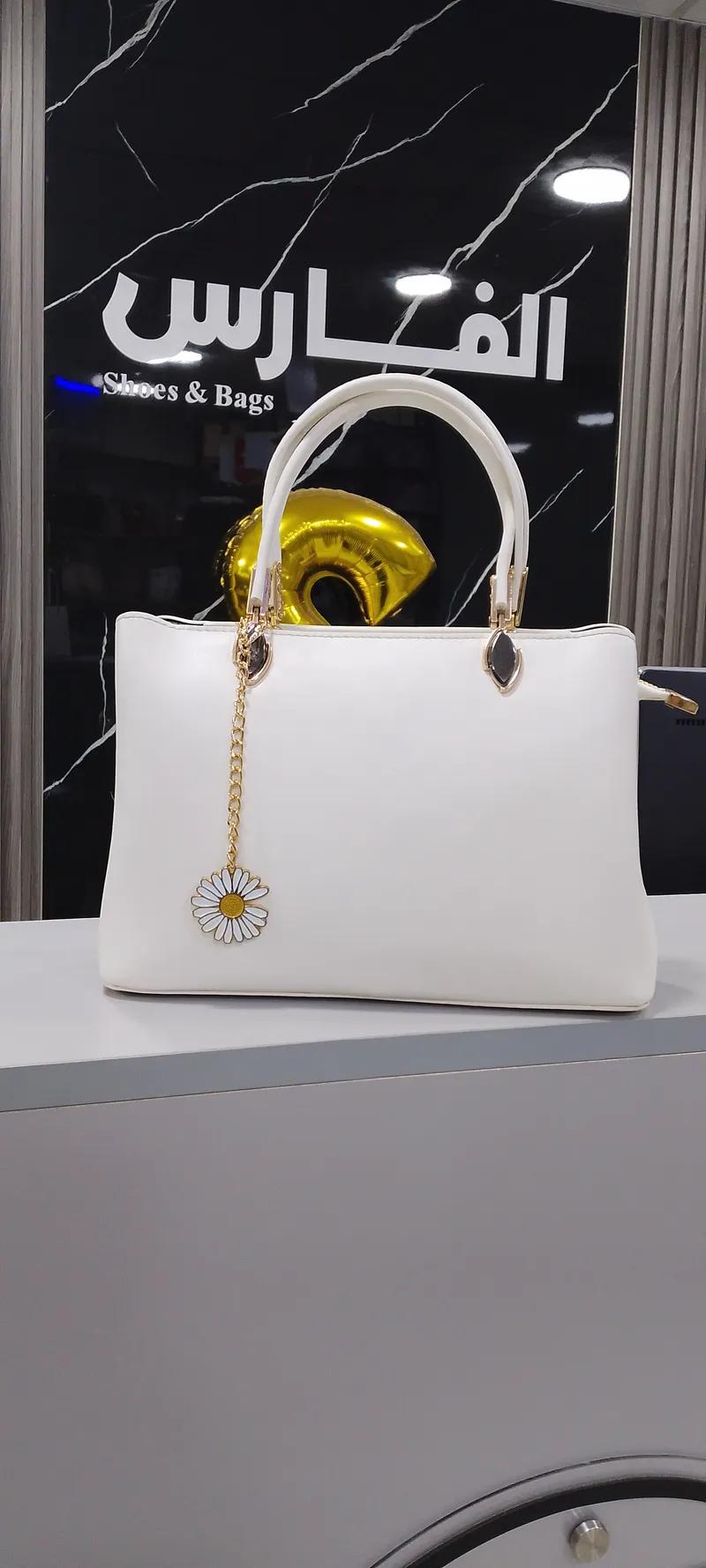 شنطة يد جلد طبيعي بميدالية للنساء